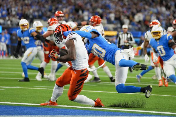 Cincinnati Bengals wide receiver Ja'Marr Chase (1) catches a touchdown past Los Angeles Chargers cornerback Cam Hart (20) during the second half of an NFL football game Sunday, Nov. 17, 2024, in Inglewood, Calif. (AP Photo/Eric Thayer)