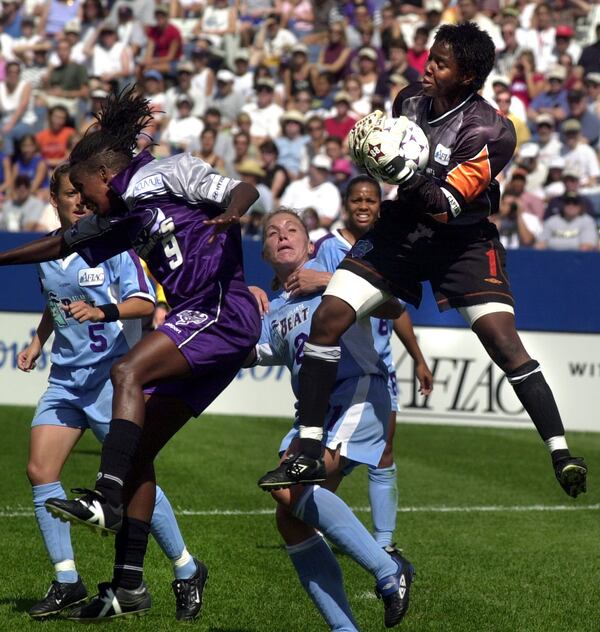 Atlanta Beat goaltender Briana Scurry graps the ball in front of the Bay Area Cyberrays Katia during the WUSA Championship Saturday, Aug. 25, 2001, in Foxboro, Mass. 