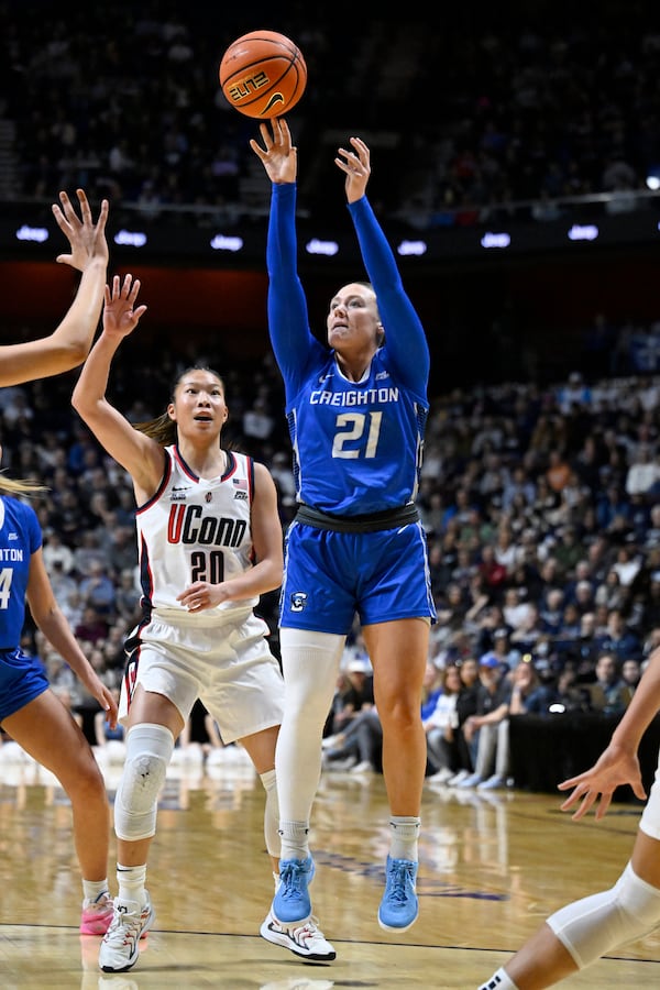 Creighton guard Molly Mogensen (21) shoots over UConn guard Kaitlyn Chen (20) during the first half of an NCAA college basketball game in the finals of the Big East Conference tournament, Monday, March 10, 2025, in Uncasville, Conn. (AP Photo/Jessica Hill)