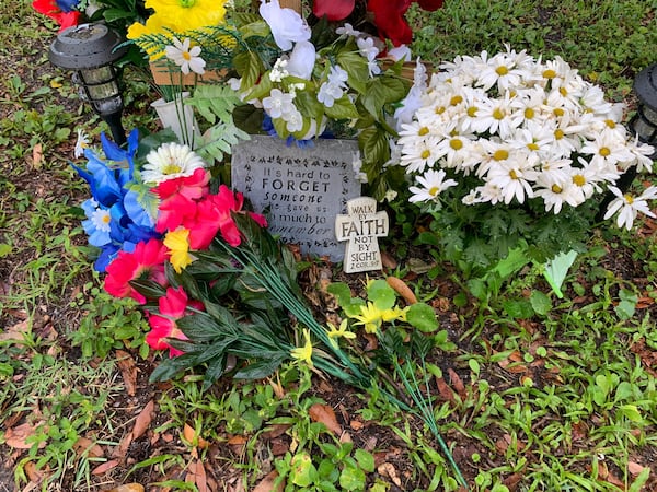 A memorial for Ahmaud Arbery sits in the front yard of a home near where the 25-year-old was killed. (Photo: Jeremy Redmon/AJC)