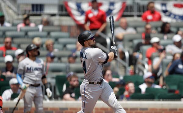 Miami Marlins' Adam Duvall watches his three-run home run hit off Atlanta Braves' Charlie Morton during the sixth inning of a baseball game Sunday, July 4, 2021, in Atlanta. (AP Photo/Ben Margot)