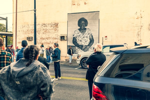 Townspeople and guests view Raymond McCrea Jones' 10-foot-tall portrait of Betty E. Slaughter. Courtesy of Andrew Hetherington