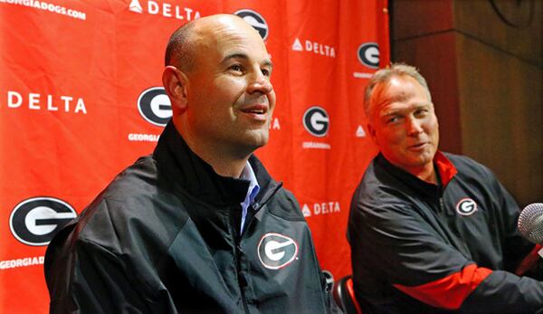 011514 ATHENS: New UGA defensive coordinator Jeremy Pruitt takes a question during his press conference with head coach Mark Richt looking on in amusement on Wednesday, Jan. 15, 2014, in Athens. Pruitt was defensive coordinator at Florida State where he won a national championship this season. CURTIS COMPTON / CCOMPTON@AJC.COM "See if you can get me higher grade than 7.9, Jeremy." (Curtis Compton/AJC)