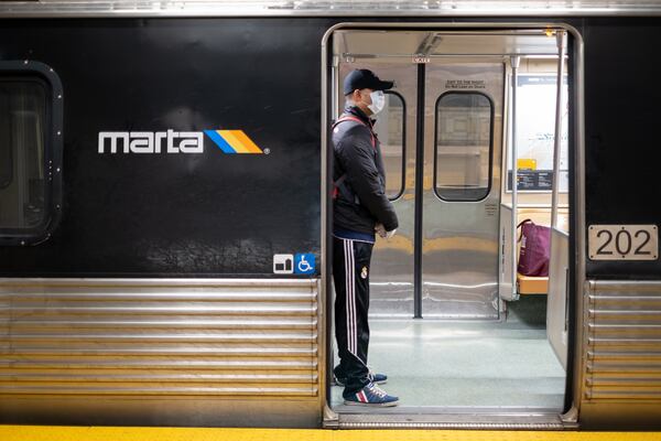 Ranjan Roy waits on a nearly empty train at the Five Points MARTA station during rush hour Friday morning March 20, 2020 while waiting for a train to take him to his work at Georgia State University. Roy said he normally has to arrive 15 minutes earlier because of the crowds at the station. Ben@BenGray.com  for the Atlanta Journal-Constitution