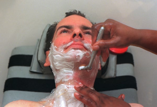 David Jayne gets a shave from caregiver Rose Delisser. His children like his face smooth and he likes a close shave because it makes him look and feel better. (RICH ADDICKS / Staff)