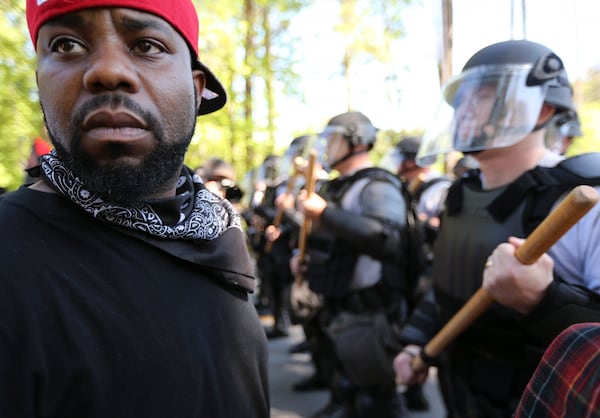 LaJuan Williams turns away from police while taking part in a counter protest at Stone Mountain Park in April 2016. Counter protest organizers said they became aware of Russian attempts to meddle in their event last fall when Twitter and Facebook began deleting Russian false accounts. BEN GRAY / AJC