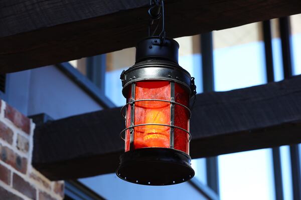 One of several railroad-style lanterns from the 1967 Dwarf House hangs inside the main entrance of the newly renovated restaurant. Curtis Compton / Curtis.Compton@ajc.com