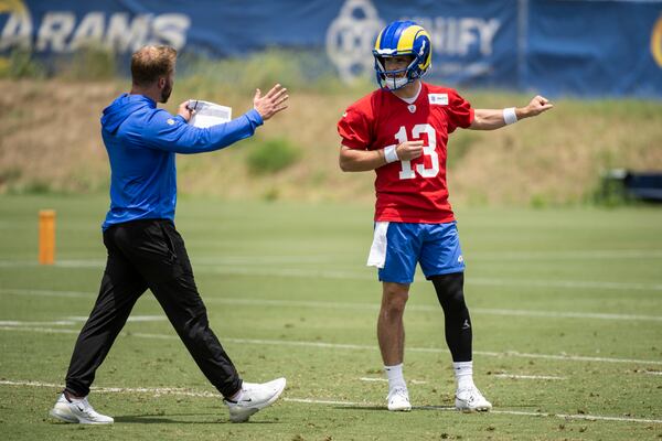 Los Angeles Rams head coach Sean McVay, left, talks to quarterback Stetson Bennett during the NFL football team's camp, Tuesday, June 13, 2023, in Thousand Oaks, Calif. (AP Photo/Kyusung Gong)