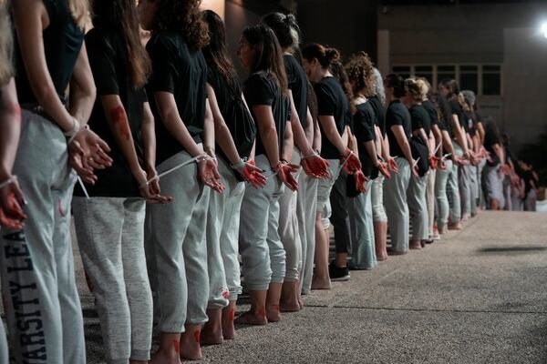 Women demonstrators take part in a performance calling for the release of hostage Naama Levy, held in the Gaza Strip by the Hamas militant group, in Tel Aviv, Israel, Saturday, Oct. 19, 2024. (AP Photo/Mahmoud Illean)