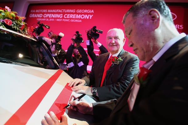 Then-Gov. Sonny Perdue, center, shown at the ceremonial opening of the Kia plant in West Point in 2010, considered the automaker's decision to come to Georgia a crowning achievement of his administration.