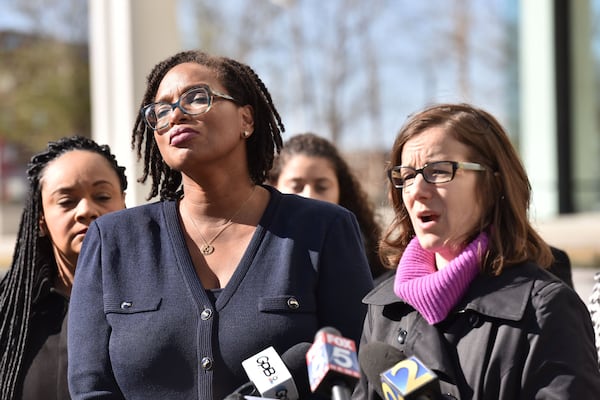 Allegra Lawrence-Hardy (foreground left), campaign chairwoman for former gubernatorial candidate Stacey Abrams, reacts as Lauren Groh-Wargo (right), CEO of Fair Fight Action and Abrams’ campaign manager, speaks to members of the press outside the Richard B. Russell Federal Building in Atlanta on Tuesday, Nov. 27, 2018. A federal lawsuit backed by Abrams will attempt to overhaul the state’s elections, alleging “gross mismanagement” after Georgians suffered long lines, uncounted ballots and purged registrations during this month’s vote. HYOSUB SHIN / HSHIN@AJC.COM