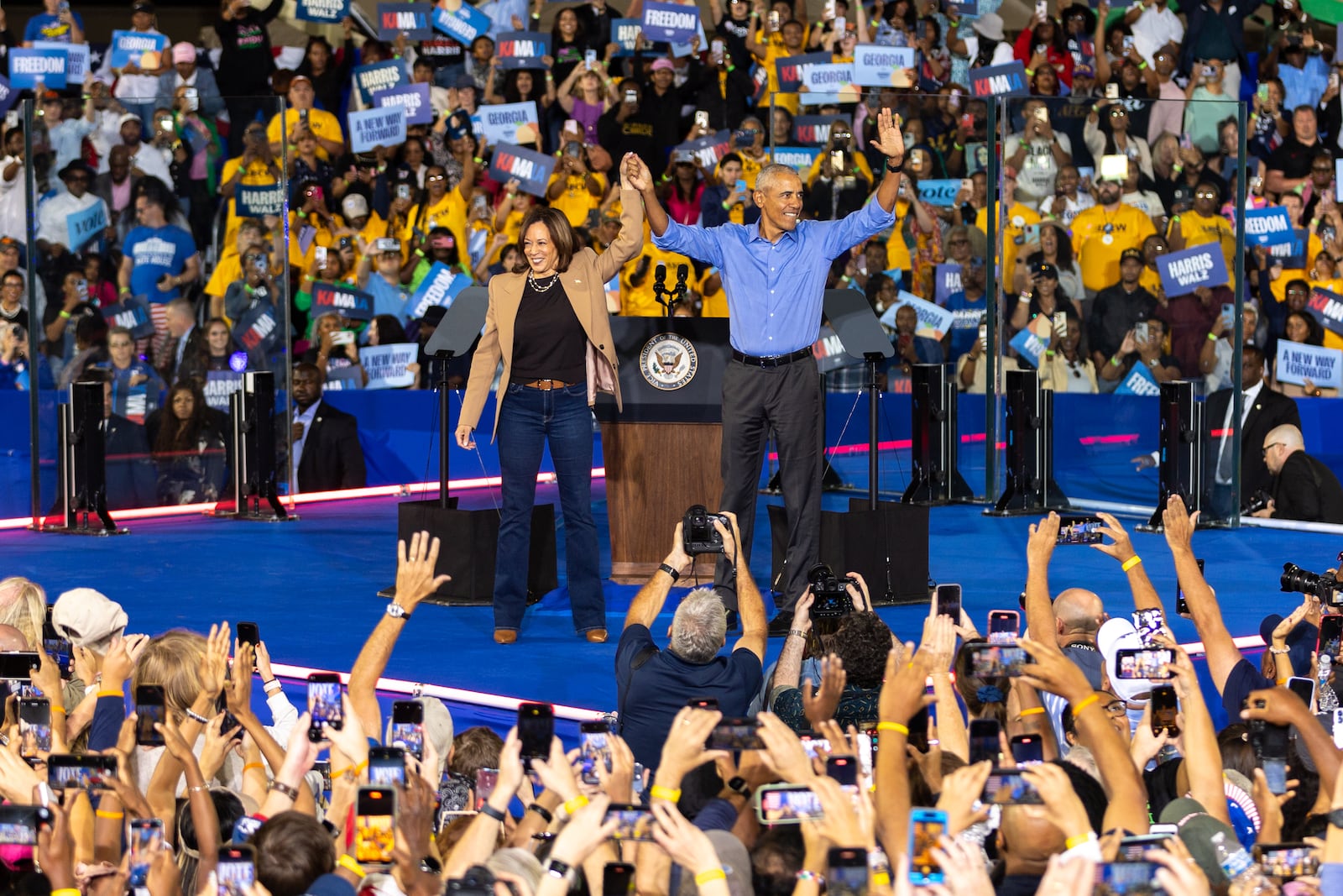 Democratic presidential candidate Kamala Harris and former President Barack Obama celebrate at the end of Harris’ campaign rally Thursday in Clarkston. (Arvin Temkar/AJC)