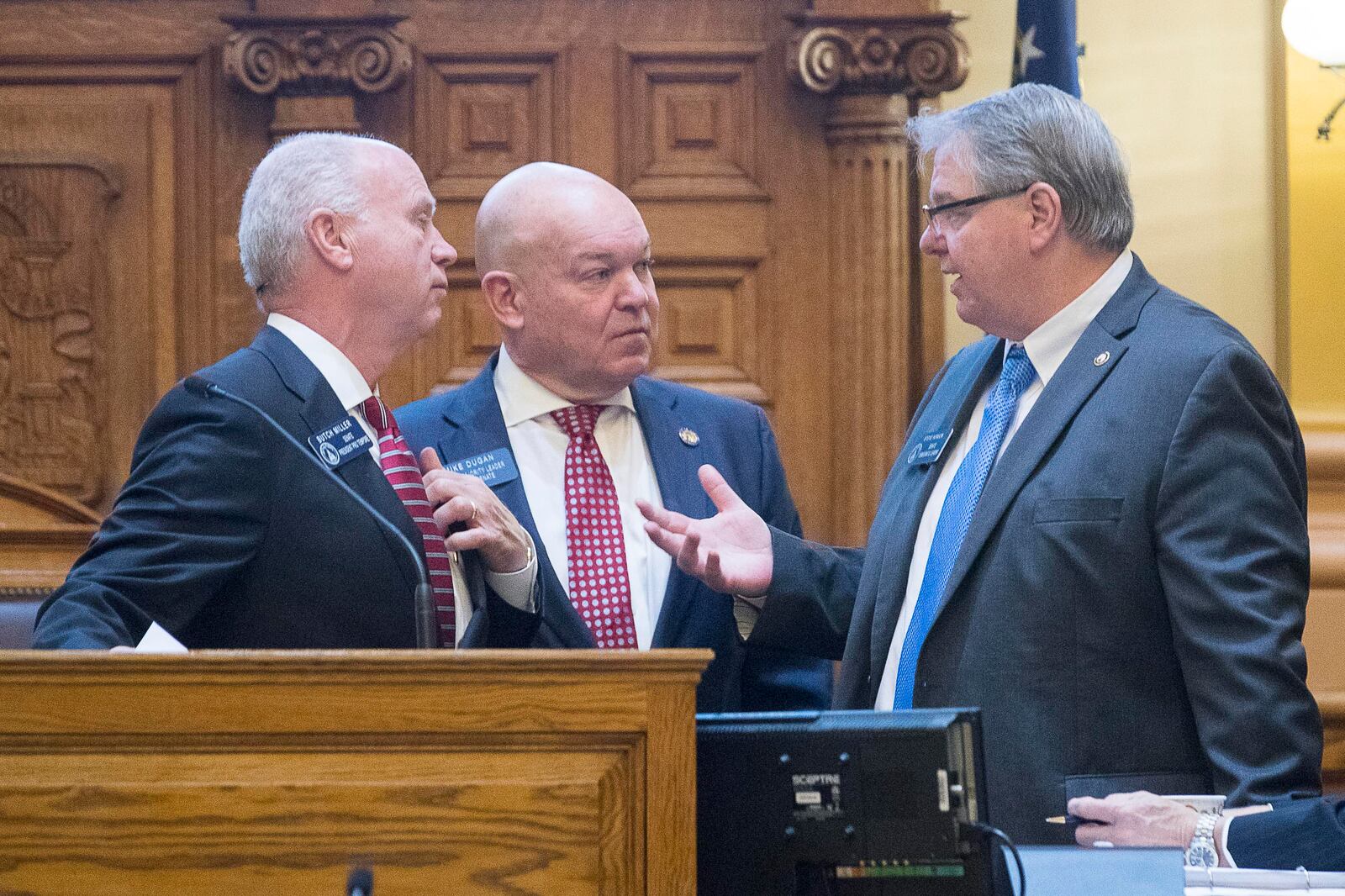 01/14/2019 -- Atlanta, Georgia -- Senate Pro Temper Butch Miller (left), Senate majority leader Mike Dugan (center) and Senate minority leader Steve Hensons (right) have a discussion over Senate Bill 4 during the first session of the season in the Senate chambers at the State Capitol building, Monday, January 14, 2019. (ALYSSA POINTER/ALYSSA.POINTER@AJC.COM)