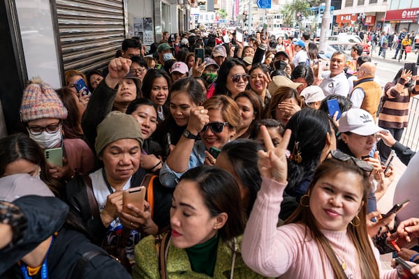 Supporters of former populist President of the Philippines Rodrigo Duterte waits for his arrival at a thanksgiving gathering organized by Hong Kong-based Filipino workers in Hong Kong on Sunday, March 9, 2025. (AP Photo/Vernon Yuen)