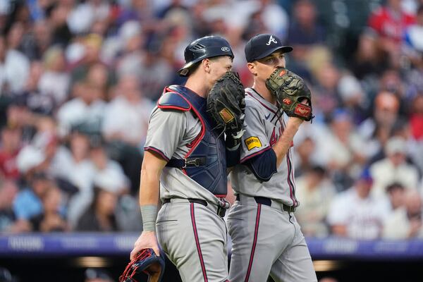 Atlanta Braves catcher Sean Murphy, left, confers with starting pitcher Max Fried, right, in the third inning of a baseball game against the Colorado Rockies, Saturday, Aug. 10, 2024, in Denver. (AP Photo/David Zalubowski)