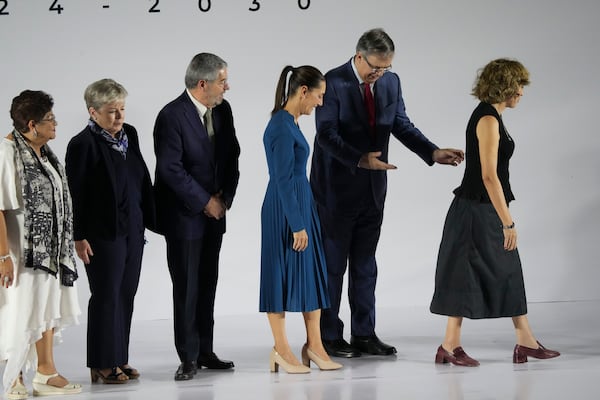 FILE - Newly-named Economy Minister Marcelo Ebrard makes a “you go first” gesture to incoming President Claudia Sheinbaum, as they exit a press conference where Sheinbaum presented six members of her Cabinet, in Mexico City, June 20, 2024. (AP Photo/Marco Ugarte, File)