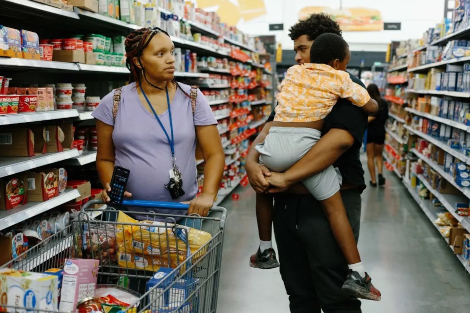 Ashley Trent grocery shops with her sons Marley (17) and Kellan (5) at Walmart Super Center in Tehachapi, CA on October 13, 2024. (Photo Courtesy of Stella Kalinina/The 19th)