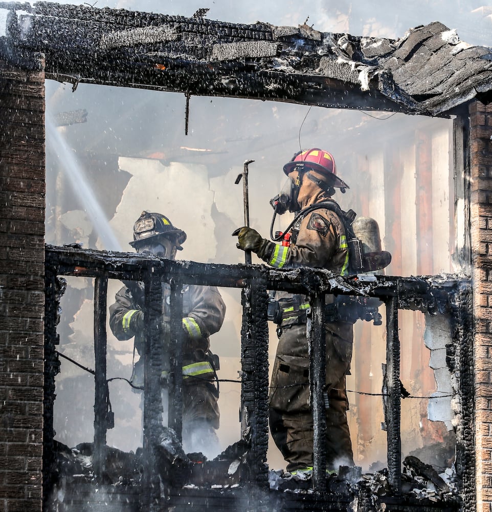 July 7, 2022 Atlanta: Atlanta firefighters had a hot morning battling an apartment blaze in the 2200 block of Campbellton Road in Atlanta on Thursday, July 7, 2022. The call came in at 9 am for the Adams House Apartments where units arrived to heavy smoke conditions according to Atlanta Fire Rescue Captain Taurus Durrah. Flames erupted from the bottom floor to the top floor and then the attic Durrah said. Crews initially had to bring in tank water to get water on the fire because of the 800 foot distance to the hydrant on Campbellton Road. Four units were damaged and 8-families displaced. No one was injured and the fire is under investigation. Durrah said more units are being sent to fire scene to shorten the rotation of fire crews due to the heat. Firefighters are told to hydrate  and stay cool a full shift before coming to work to combat the heat. (John Spink / John.Spink@ajc.com)


