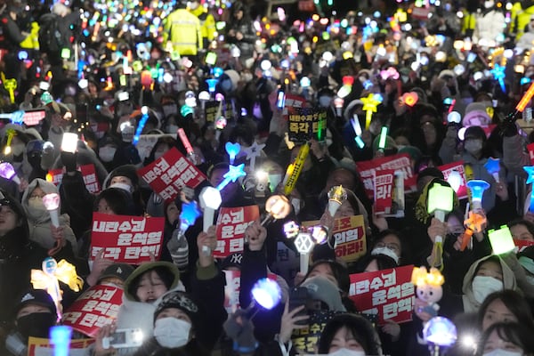 Participants stage a rally to demand South Korean President Yoon Suk Yeol's impeachment, outside the National Assembly in Seoul, South Korea, Wednesday, Dec. 11, 2024. (AP Photo/Ahnn Young-joon)