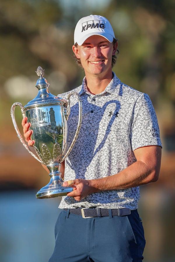 Maverick McNealy holds the trophy after the final round of the RSM Classic golf tournament, Sunday, Nov. 24, 2024, in St. Simons Island, Ga. (AP Photo/Gary McCullough)