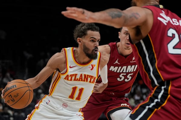 Atlanta Hawks guard Trae Young (11) drives against Miami Heat forward Duncan Robinson (55) during the first half of an NBA basketball game, Monday, Feb. 24, 2025, in Atlanta. (AP Photo/Mike Stewart)