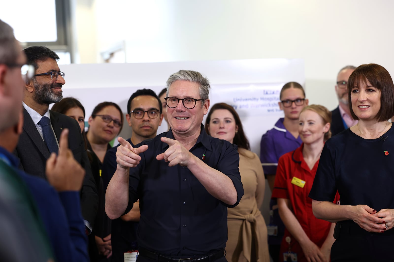 Britain's Prime Minister Keir Starmer and Chancellor Rachel Reeves speak with members of staff, during a visit to University Hospital Coventry and Warwickshire, in Coventry, England, Thursday, Oct. 31, 2024. (AP Photo/Darren Staples, pool)