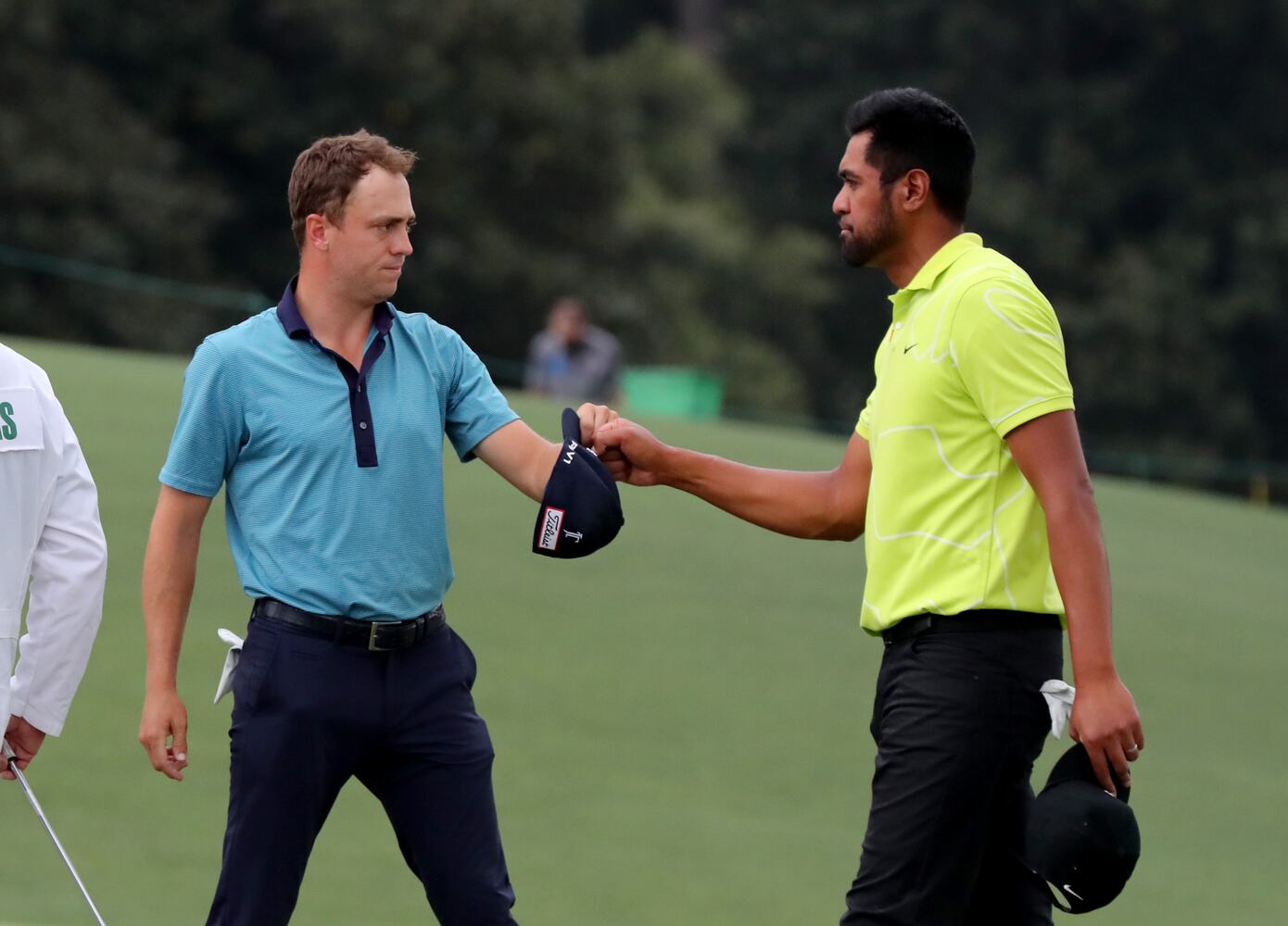 April 9, 2021, Augusta: Justin Thomas, left, and Tony Finau fist bump as they finish their second round on the eighteenth green during the Masters at Augusta National Golf Club on Friday, April 9, 2021, in Augusta. Curtis Compton/ccompton@ajc.com