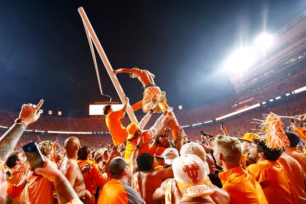 Fans tear down a goal post after an NCAA college football game between Tennessee and Alabama Saturday, Oct. 15, 2022, in Knoxville, Tenn. Tennessee won 52-49. (AP Photo/Wade Payne)