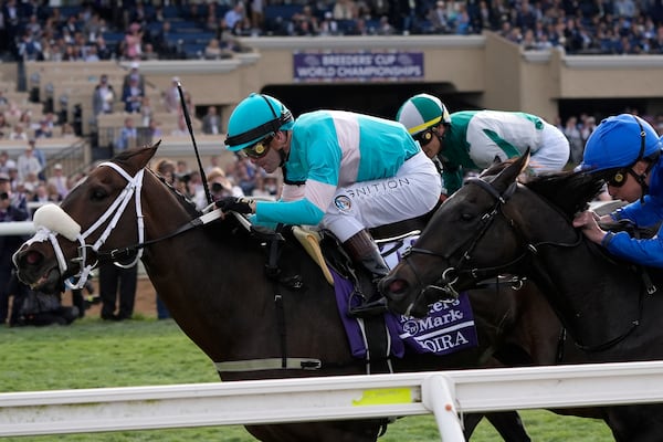 Flavien Prat rides Moira, left, to victory in the Breeders' Cup Filly and Mare Turf horse race in Del Mar, Calif., Saturday, Nov. 2, 2024. (AP Photo/Gregory Bull)