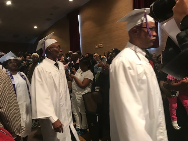 Students from the Pike County Consolidated High School Class of 1969 walk down the aisle at the beginning of a graduation ceremony Sat., March 3, 2018 to receive their high school diplomas. ERIC STIRGUS / ESTIRGUS@AJC.COM