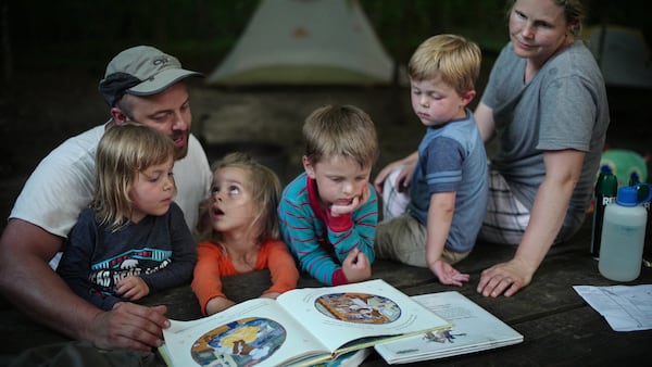 Lydia Haschig, 3, asks a question during story time as brother Gus, 5, looks on next to her. Her uncle Joe Malkovich, aunt Sarah, and cousins Hannah and Daniel, 5 and 3, brought them to camp for one night.]  At William O'Brien State Park exemplifies camping's popularity across the state ballooning as more Minnesotans seek inexpensive, close-to-home vacations and experience the mental and physical health benefits of spending time in nature. (Richard Tsong-Taatarii/Minneapolis Star Tribune/TNS)