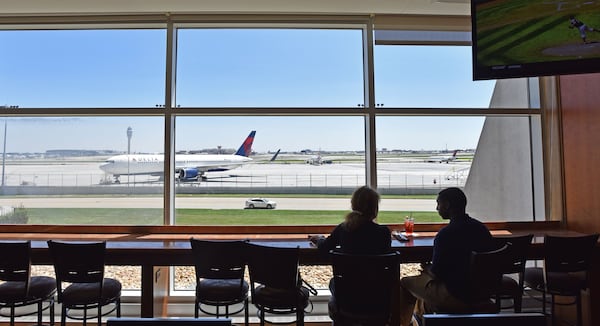 In this photo taken in August 2015, Vicki Van Der Hoek (left) and Leon Shields talk at the Renaissance Concourse Atlanta Airport Hotel. Vicki and Leon would often come to the bar watching planes. HYOSUB SHIN / HSHIN@AJC.COM