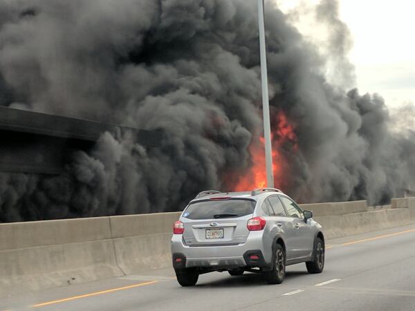 A car drives by the fire on I-85 Thursday evening. (Credit: Jackson Klinefelter)