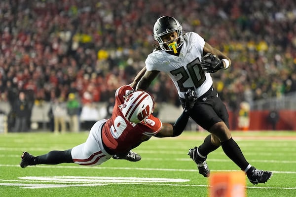 Wisconsin's Austin Brown (9) stops Oregon's Jordan James (20) during the second half of an NCAA college football game Saturday, Nov. 16, 2024, in Madison, Wis. Oregon won 16-13. (AP Photo/Morry Gash)