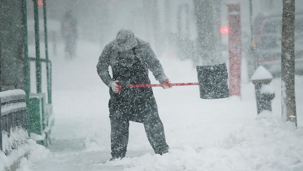 FILE PHOTO: A man shovels snow in the Brooklyn borough of New York City.  (Photo by Spencer Platt/Getty Images)