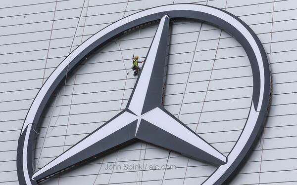 Work continued Wednesday on the new Mercedes-Benz Stadium ahead of another round of showers in metro Atlanta. JOHN SPINK / JSPINK@AJC.COM