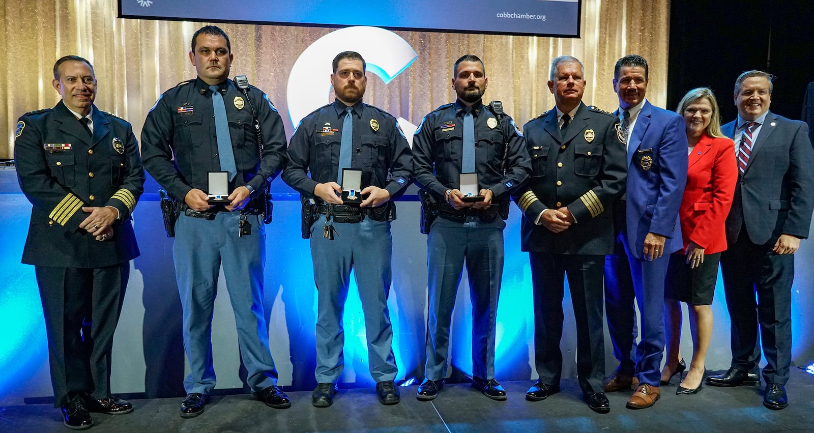 Among the Cobb Chamber public safety award winners on Oct. 4 are (l-r, holding their Medals of Valor) Cobb County Police Officers David Cavender, John Pearson and Bryan Moore for their actions during a firefight with an armed carjacker in June 2020. Cavender was wounded during the incident and the suspect killed. (Courtesy of Cobb Chamber)