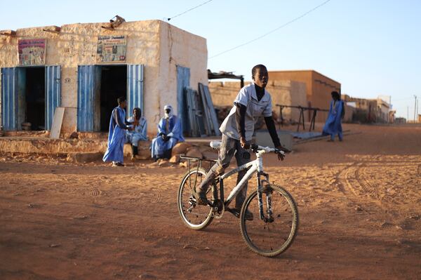 A child rides his bike in Chinguetti, Mauritania on Feb. 4, 2025. (AP Photo/Khaled Moulay)