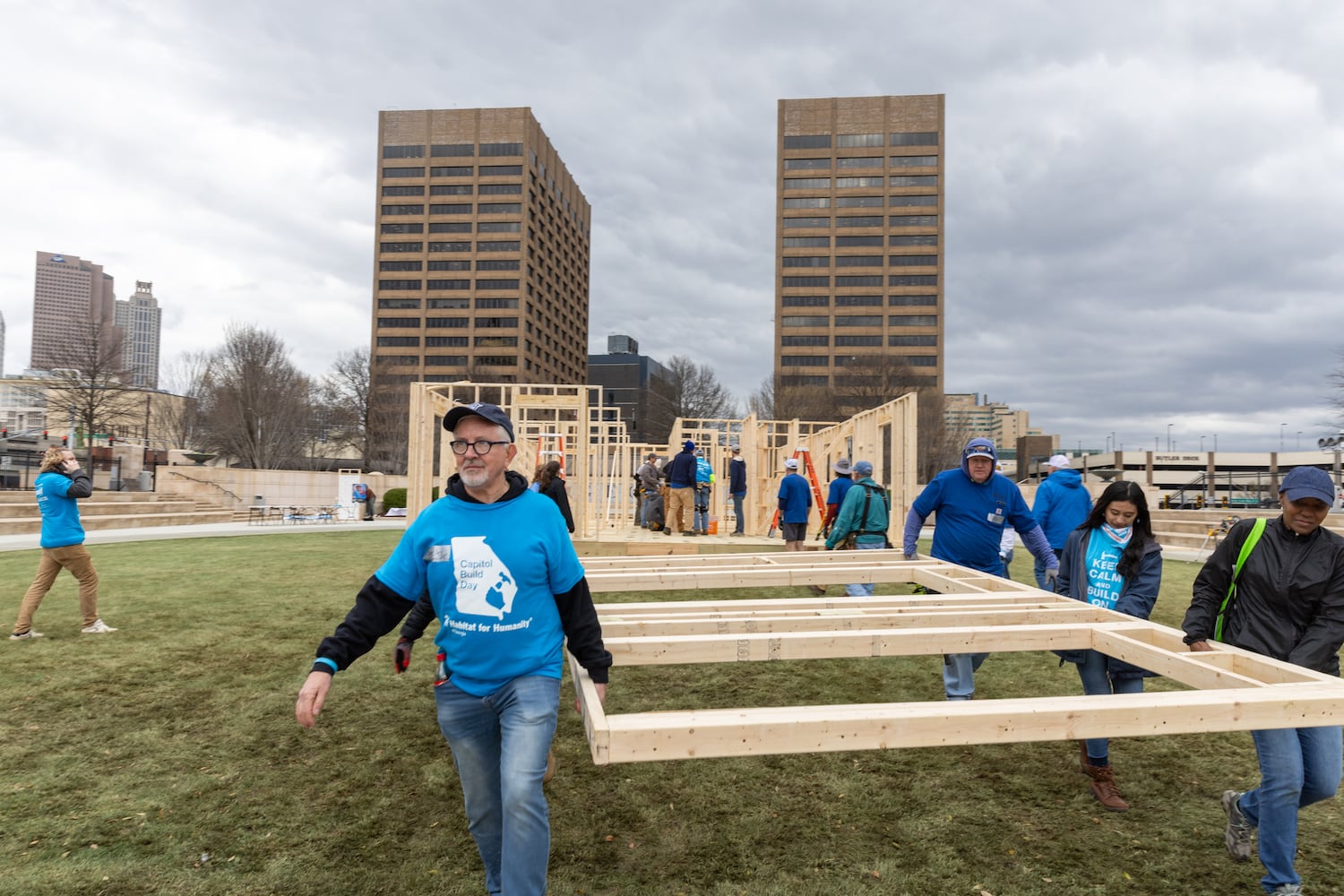 Habitat for Humanity volunteers take down the frame of a home built at Liberty Plaza, outside the Capitol, in Atlanta on Wednesday, March 5, 2025. The frame will be transported and used to house a family. (Arvin Temkar / AJC)