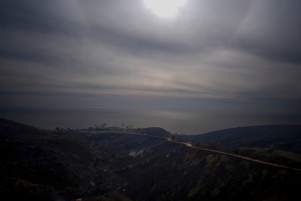 A mountain top overlooking the Pacific Ocean is scarred after the Franklin Fire swept through Wednesday, Dec. 11, 2024, in Malibu, Calif. (AP Photo/Eric Thayer)