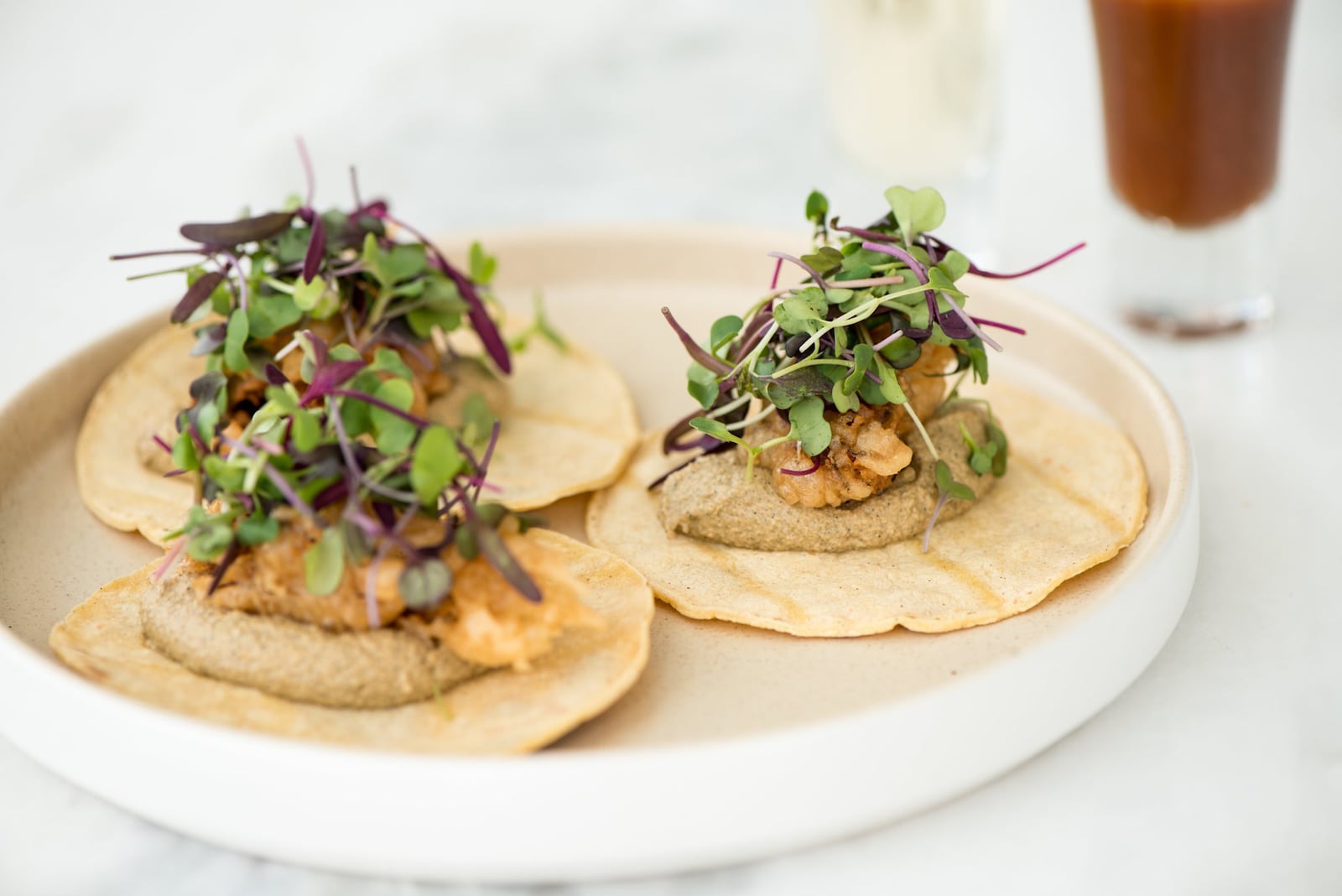 Oyster Tacos, with tempura fried oysters, dzikilpak, onions, and cilantro. Photo credit- Mia Yakel.