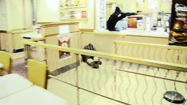 A frame grab from security video at an Omaha, Neb., Wendy's restaurant shows an alleged armed robbery at the restaurant on the night of Aug. 26, 2014. Newly released footage shot by a "Cops" cameraman shows the police shooting that killed the man in the hooded sweatshirt, Cortez Washington, as well as Bryce Dion, a "Cops" crew member.