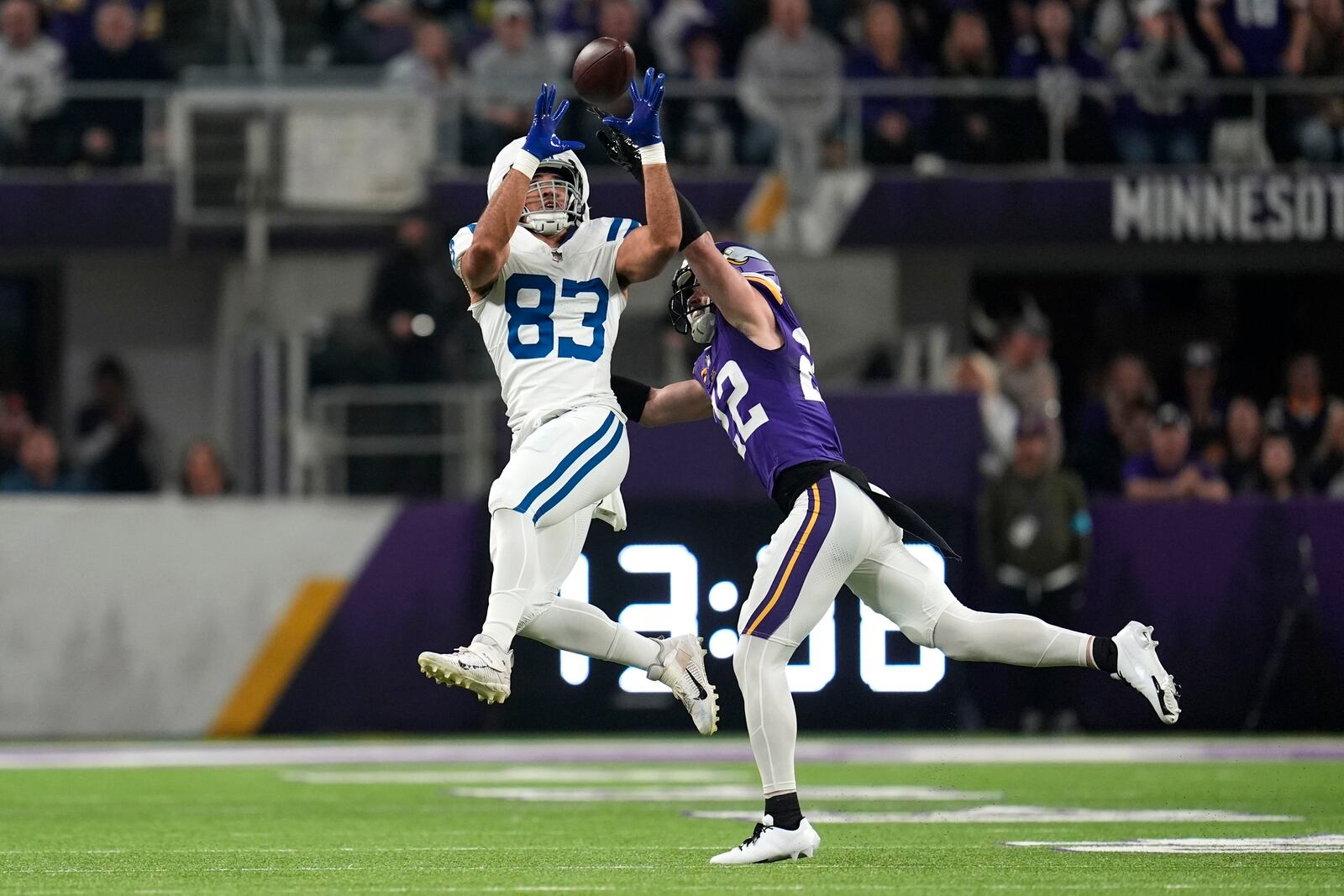 Indianapolis Colts tight end Kylen Granson (83) catches a pass over Minnesota Vikings safety Harrison Smith (22) during the first half of an NFL football game, Sunday, Nov. 3, 2024, in Minneapolis. (AP Photo/Abbie Parr)