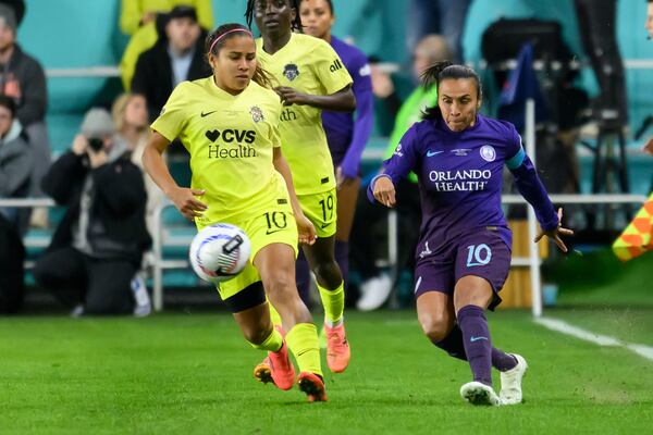 Orlando Pride forward Marta (10) and Washington Spirit midfielder Leicy Santos (10) battle for the ball during the first half of the NWSL championship at CPKC Stadium, Saturday, November 23, 2024, in Kansas City, Mo. (AP Photo/Reed Hoffmann)