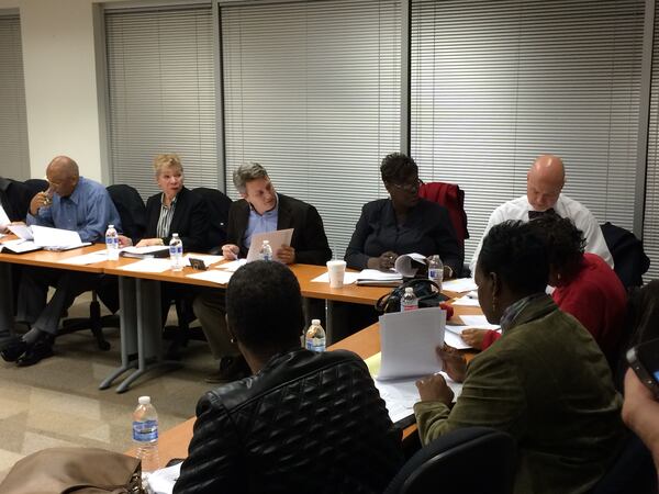 The DeKalb County Board of Ethics met on Dec. 18, 2014, to discuss hiring an executive officer and to consider a complaint against Commissioner Larry Johnson, which was dismissed. From left: Robert Blackman, Bobbie Kennedy Sanford, John Ernst, Thelma Grier and board attorney Gene Chapman. In the foreground are board members Clara Black-Delay and Edwinett Fay Perkins-Murphy. (MARK NIESSE / MARK.NIESSE@AJC.COM) Ethics Board Chairman John Ernst, third from left in this December 2014 photo, has requested state and federal criminal investigations into an invalid ethics document. MARK NIESSE/MARK.NIESSE@AJC.COM