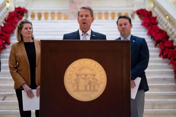 221208-Atlanta-House Speaker Jan Jones (R-Milton), left and Lt. Gov. elect Burt Jones (R-Jackson) flank Gov. Brian Kemp as he announces some of his Legislative agenda during a press conference Thursday, Dec. 8, 2022 at the State Capitol. Ben Gray for the Atlanta Journal-Constitution