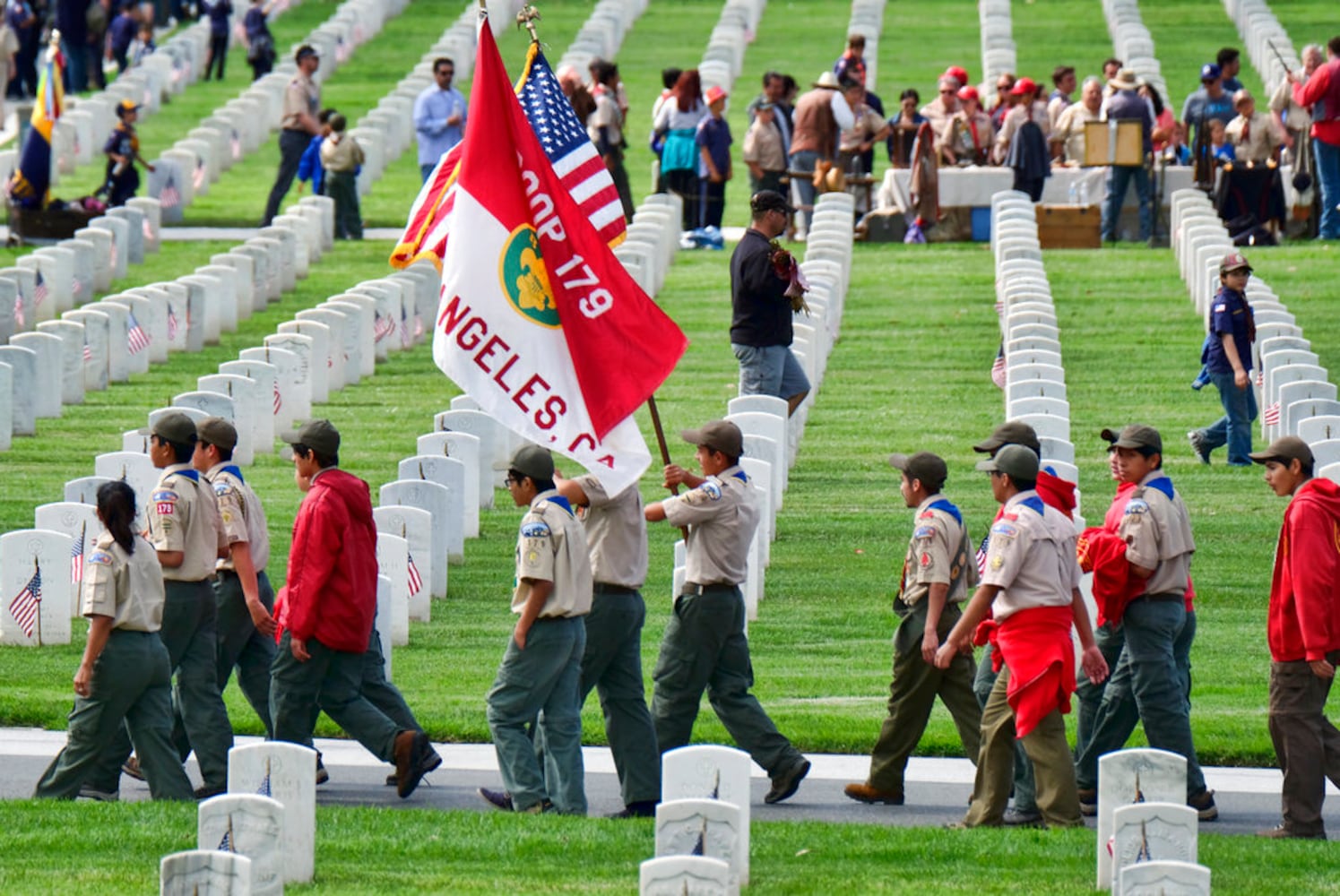 scouts place flags at veteran graves to honor memorial day