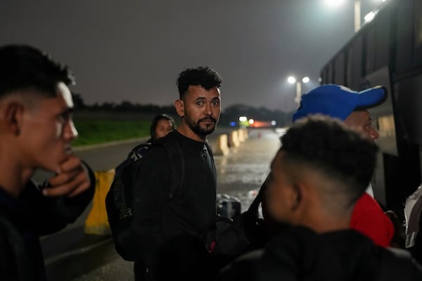 Diego, a Honduran migrant, gets on a bus in the hope of reaching the U.S., after being deported from that country, in San Pedro Sula, Honduras, Tuesday, Dec. 3, 2024. (AP Photo/Moises Castillo)