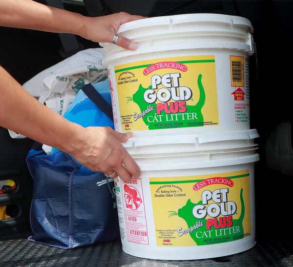 Sonya Shah of Atlanta has been using the same cat litter containers to buy bulk cat litter since 2001. CURTIS COMPTON / CCOMPTON@AJC.COM