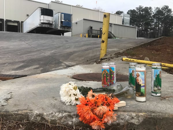 Flowers and candles are seen outside the Foundation Food Group poultry processing plant in Gainesville, Georgia, on Saturday, Jan. 30, 2021. (Photo: Vanessa McCray / Vanessa.McCray@ajc.com)